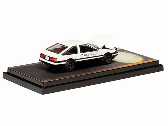 White and black Toyota Sprinter Trueno AE86 diecast model car, right-hand drive, engine-mounted, 1/64 scale, detailed replica.