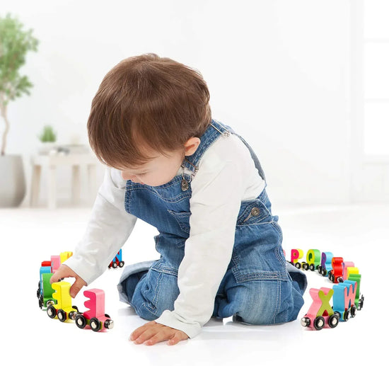 Magnetic wooden alphabet train set for toddlers with engine and letter cars, compatible with major brand train tracks.