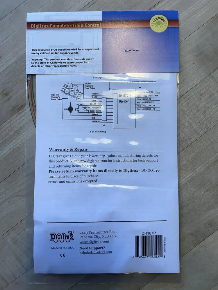 HO scale Digitrax DH187P digital decoder module for model trains, showing circuit board and connection ports.