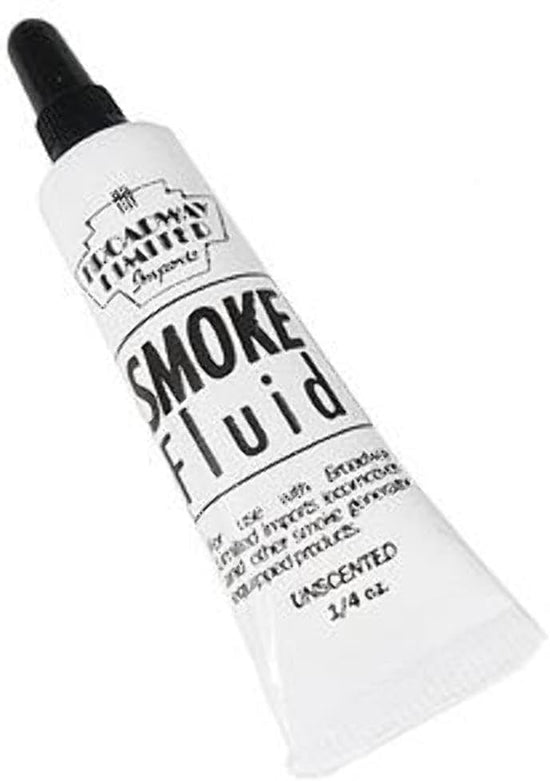 Close-up of Broadway Limited Imports smoke fluid bottle for model train tracks, showing the 0.25oz cleaner and lubricant container