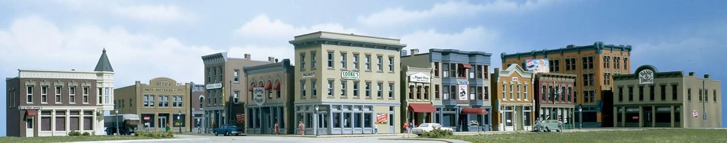 N Scale Woodland Scenics town and factory building set with detailed miniature buildings for model train layouts.