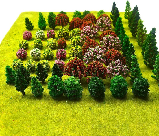 Assorted miniature artificial trees for model train scenery and dioramas, featuring various small tree types by MOMOONNON.