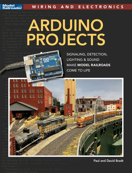 Open Arduino project development handbook showing pages with circuit diagrams and code examples for electronics projects.