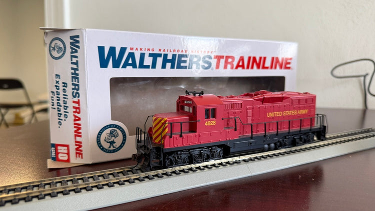Pre-owned Walthers HO US Army GP9M locomotive by BYMRR Train Store, detailed model with military green paint and realistic features