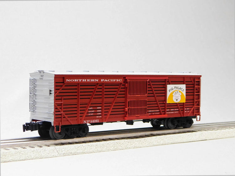 Three VISIONLINE Northern Pacific stock cars in O gauge model 2226900, detailed miniature freight cars on a model train track
