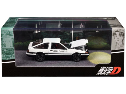 White and black Toyota Sprinter Trueno AE86 diecast model car, right-hand drive, 1/64 scale, mounted engine, detailed display.