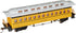 Bachmann yellow passenger car for model railroads, detailed prototype design, sits on tracks with windows and realistic features