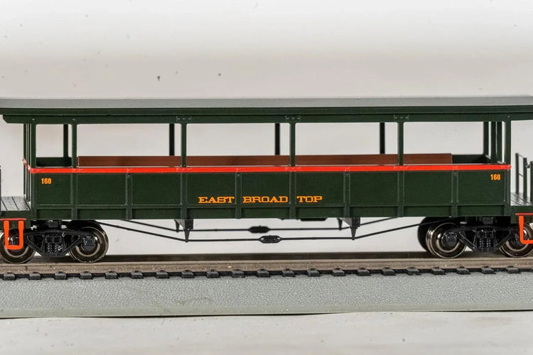 HO scale Bachmann East Broad Top open-sided excursion train car with detailed interior and vintage design.