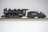 Bachmann HO scale ATSF USRA 0-6-0 locomotive with smoke and slope tender on model railway track.