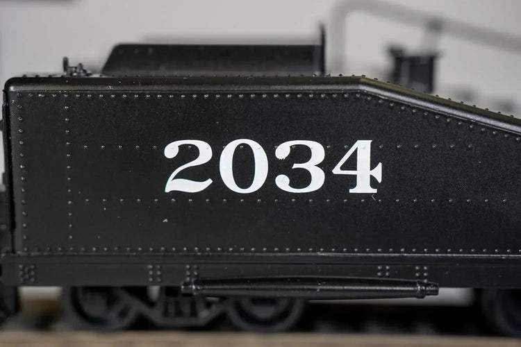 Bachmann HO scale ATSF USRA 0-6-0 locomotive with smoke and slope tender on model train track
