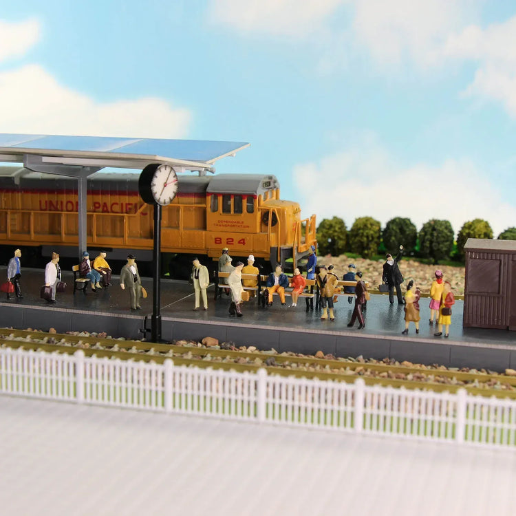 Painted HO scale passenger figures by Evemodel showing seated and standing passengers for 1:87 model train accessories.