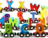 Magnetic wooden alphabet train set for toddlers with engine and letter cars, compatible with major brand train tracks.