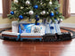 Polar Express Berkshire-style battery-operated model train set with remote control, featuring detailed train and scenic track.