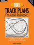 Open book showing detailed model railroad track plans from "101 Comprehensive Track Plans" model railroad handbook, Volume 3.
