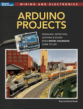 Open Arduino project development handbook showing pages with circuit diagrams and code examples for electronics projects.