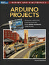 Open Arduino project development handbook showing pages with circuit diagrams and code examples for electronics projects.