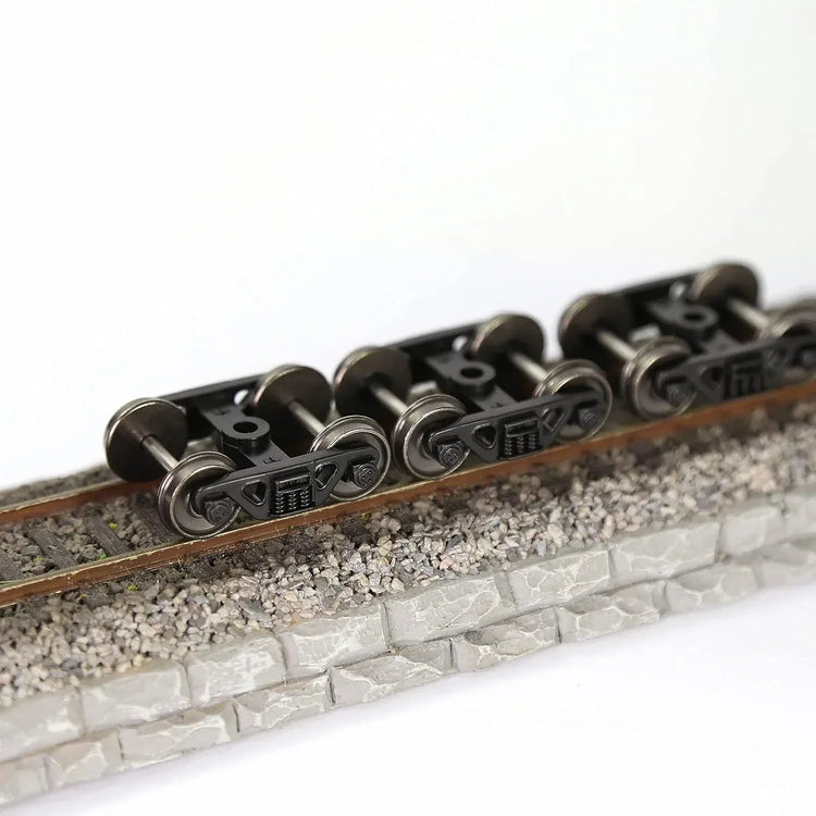 HO scale 1:87 roller bearing trucks with 36-inch metal DC wheels and triple-spring bogies by Evemodel, set of four.