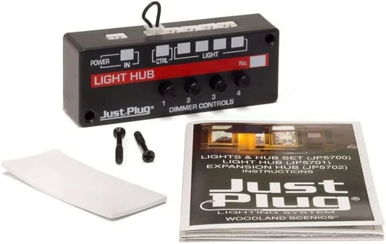 Woodland Scenics LED light hub with dimming control for four lights, showing device connected to multiple small LED lights.