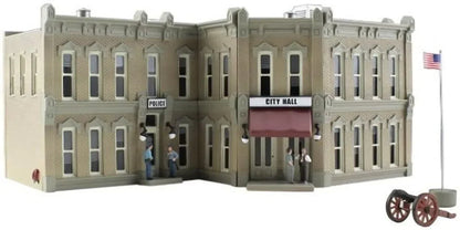 Pre-assembled Woodland Scenics municipal building model for model train layouts and dioramas, detailed and realistic urban structure.