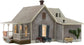 Woodland Scenics BR4933 Old Homestead N scale model kit showing a detailed miniature rural farmhouse with surrounding landscape.