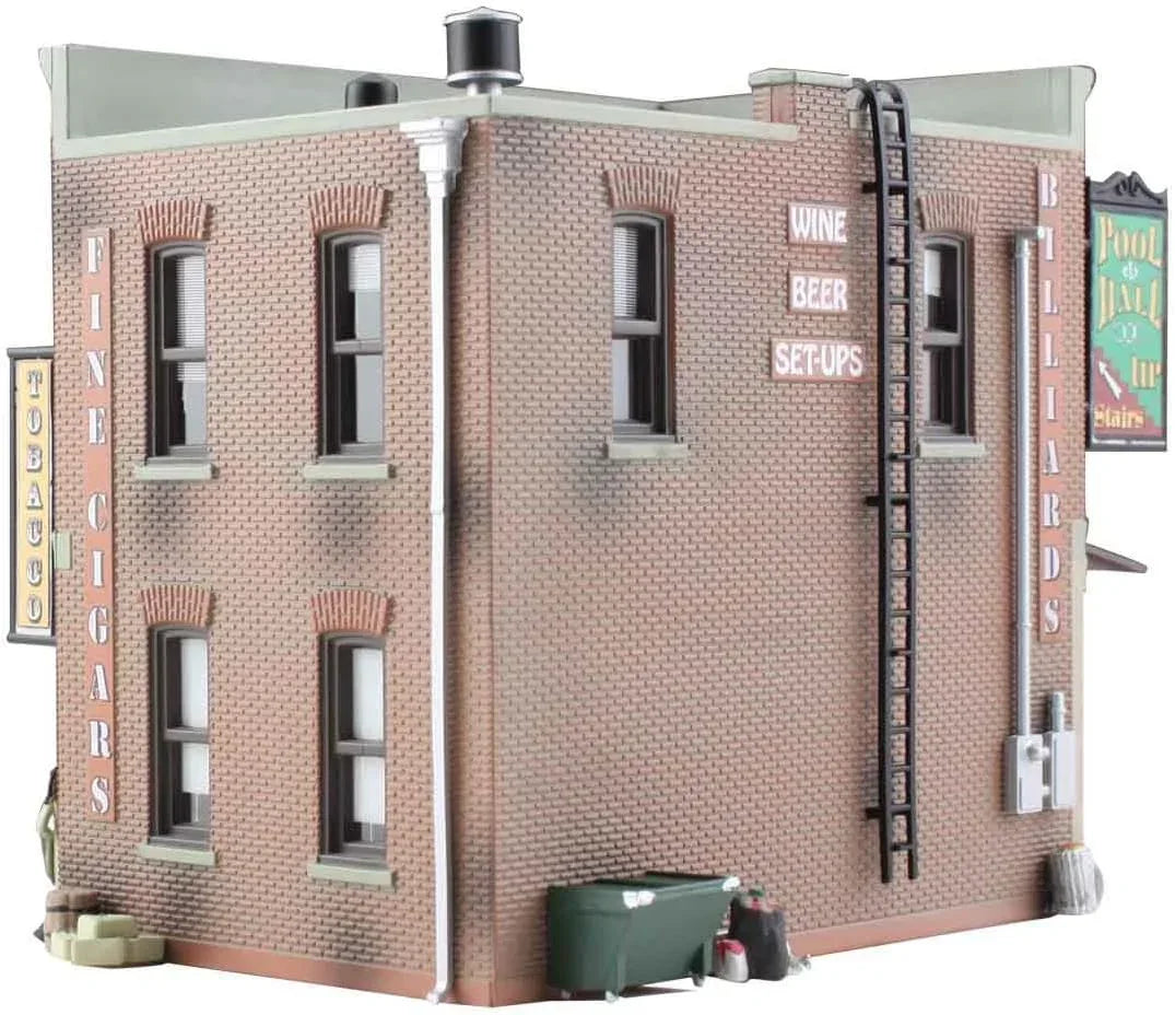 HO scale model kit of a corner emporium building by Woodland Scenics, featuring detailed miniature architecture and realistic design.