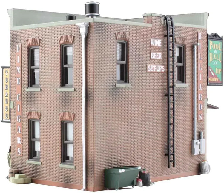 HO scale model kit of a corner emporium building by Woodland Scenics, featuring detailed miniature architecture and realistic design.