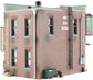 HO scale model kit of a corner emporium building by Woodland Scenics, featuring detailed miniature architecture and realistic design.