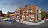 HO scale Records and Recruitment Facility model by Woodland Scenics featuring detailed building with signage and surrounding landscape.