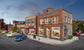 HO scale Records and Recruitment Facility model by Woodland Scenics featuring detailed building with signage and surrounding landscape.