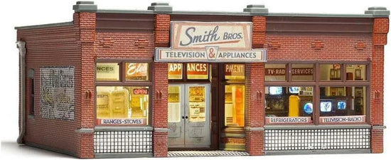 HO scale Woodland Scenics pre-assembled Smith Brothers TV & Appliance Store model, detailed miniature building for model railway layouts.